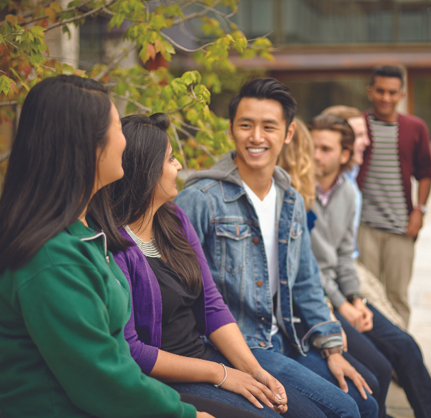 Diverse group of students sitting outside