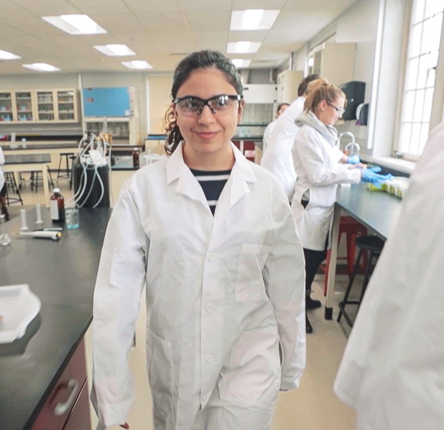 Student walking through lab