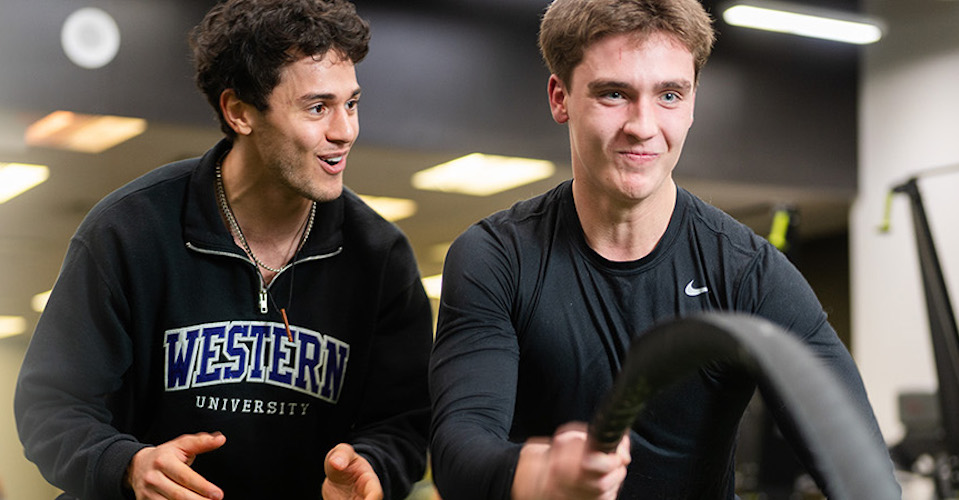 Two Western Kinesiology students in a gym