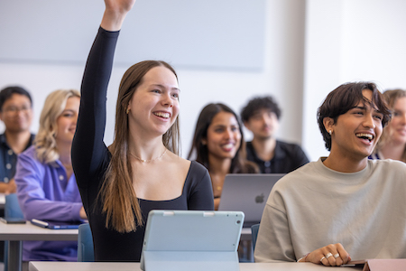 Student raising hand in class