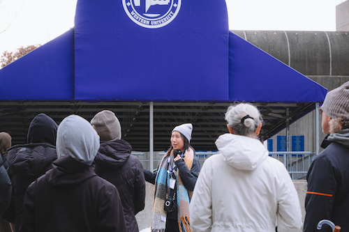 Student giving a campus tour to future students and their parents